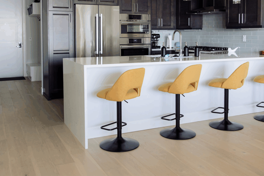 Hardwood flooring scene with barstools at a kitchen bar
